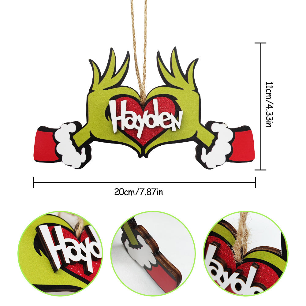 Personalized "Hayden" Grinch ornament, a unique wooden Christmas gift, heart-shaped design.